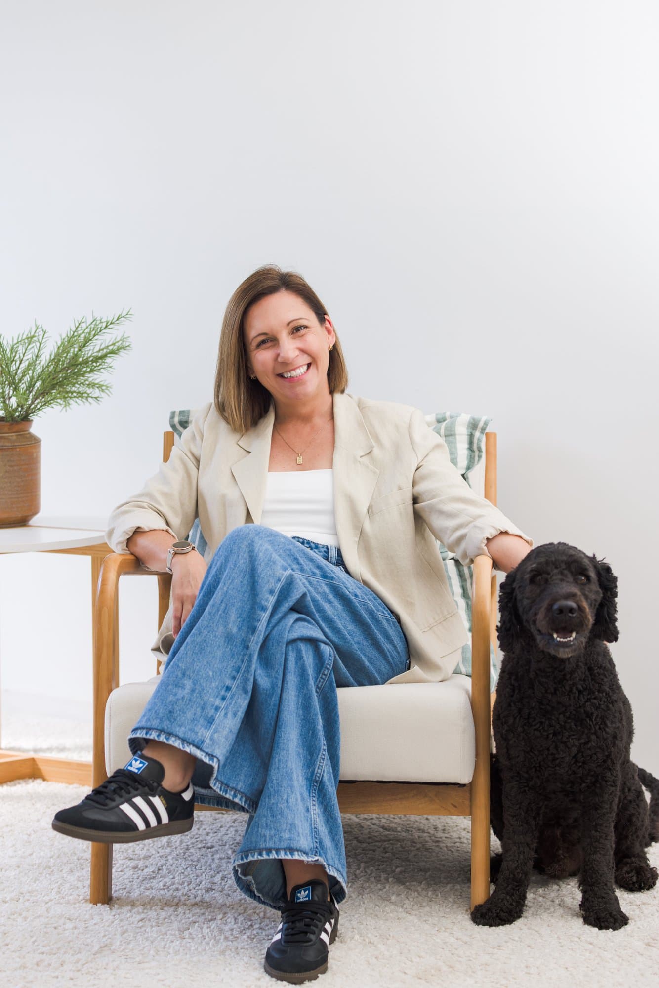 Steph Bartram relaxed in an armchair with her dog beside her