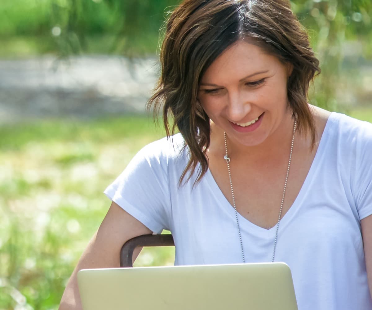 Steph working outdoors on her laptop